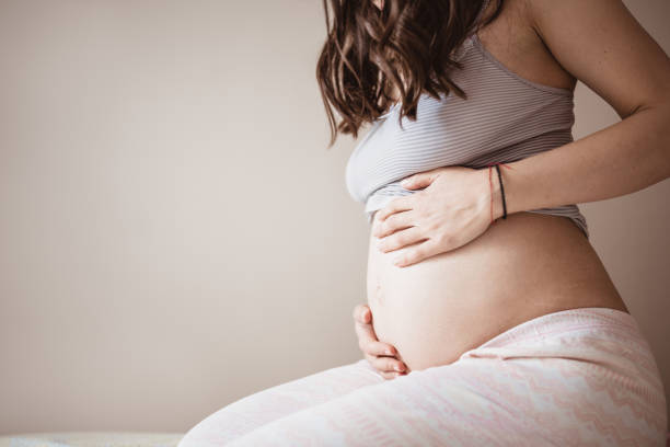 istock Young future mother examines her belly 1143234992