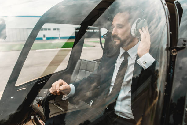 istock Calm man wearing headphone while sitting in the helicopter 1143235122