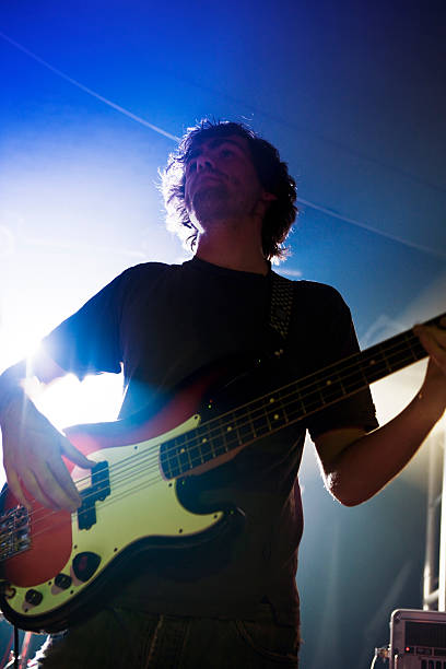 istock Bass player on stage with rock band 114323560