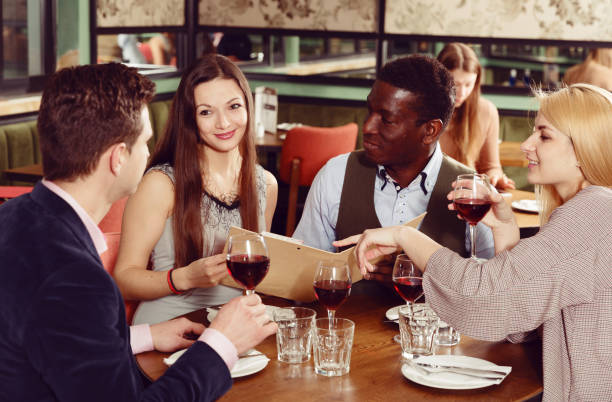 istock Friends choosing meal from restaurant menu 1143235959