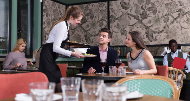 istock Waitress bringing dishes to couple 1143235984