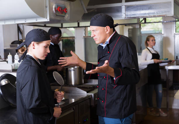 istock Chef dissatisfied with work of girl 1143236158