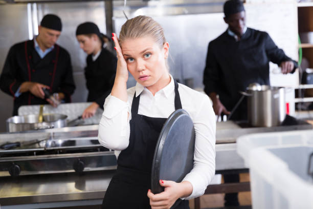 istock Unhappy waitress waiting dishes in kitchen 1143236177