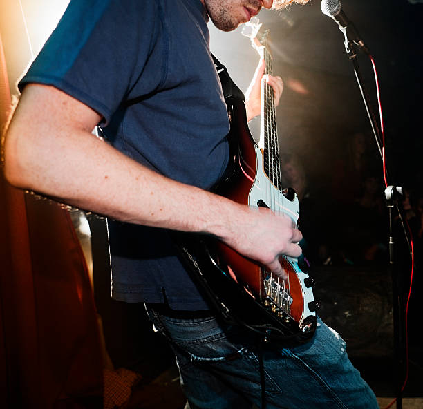 istock Bass player on stage with rock band 114323710