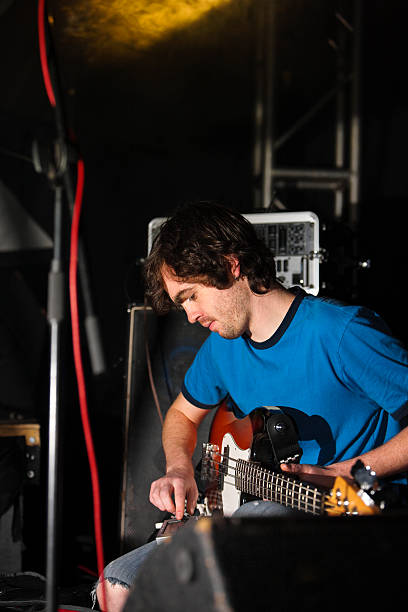 istock Bass player  tuning up on stage 114323717
