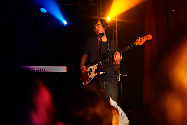istock Bass player on stage with rock band 114323736