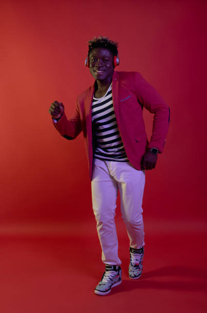 istock Smiling man is listening music and dancing 1143237500
