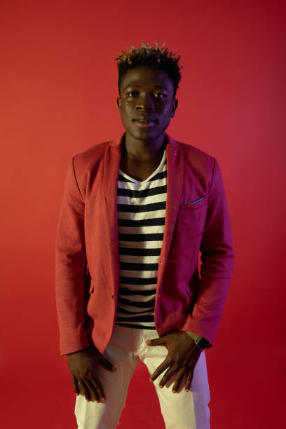 istock Stylish man is posing on red background 1143237509