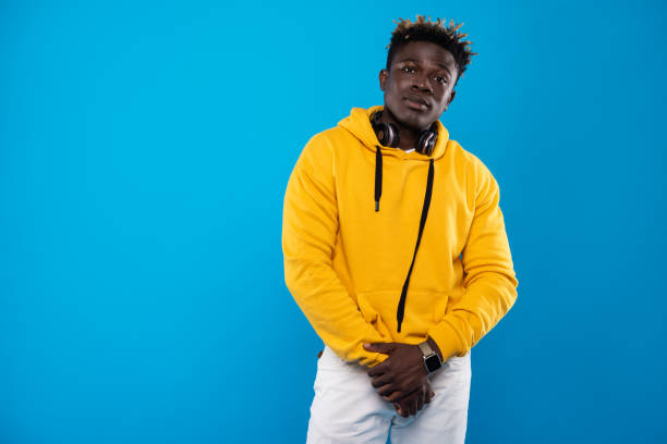 istock Young man in yellow hoodie is posing 1143237541
