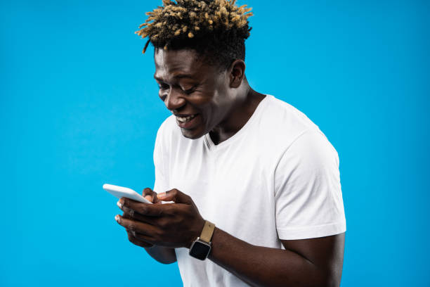 istock Young man looking at smartphone and laughing 1143237588