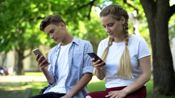 istock Teenagers using phone instead of interacting, lack of communication, addicted 1143237857