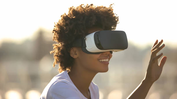 istock Beautiful woman touching air during the VR experience, future technology concept 1143238046