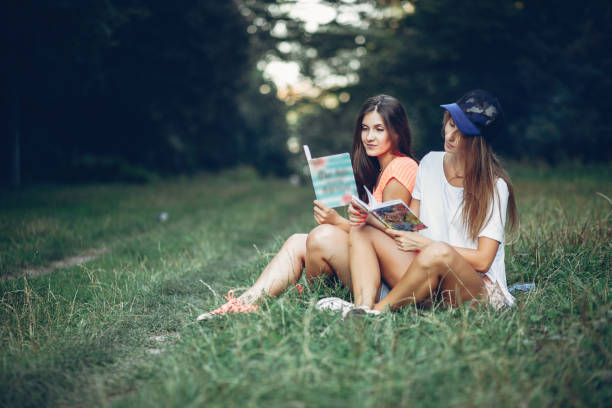 istock Two pretty girls in a summer park 1143238243