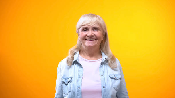istock Friendly old lady smiling on camera, concept of satisfied customer, good service 1143238409