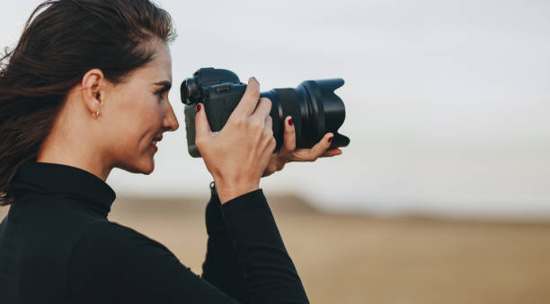 istock Female photographer taking pictures 1143241348