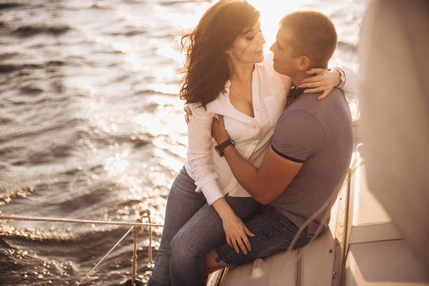 istock Romantic couple hugging on yacht at sunset 1143241413