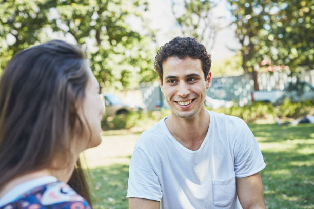 istock Young couple gaze lovingly at each other in park 1143241489