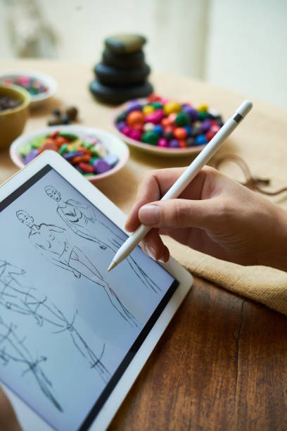 istock Drawing sketches of clothes on digital tablet 1143241610
