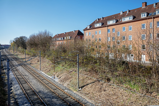 Valby, Copenhagen, Denmark - April 15, 2019: Typical house with flats close to the railroad tracks in a suburb outside Copenhagen