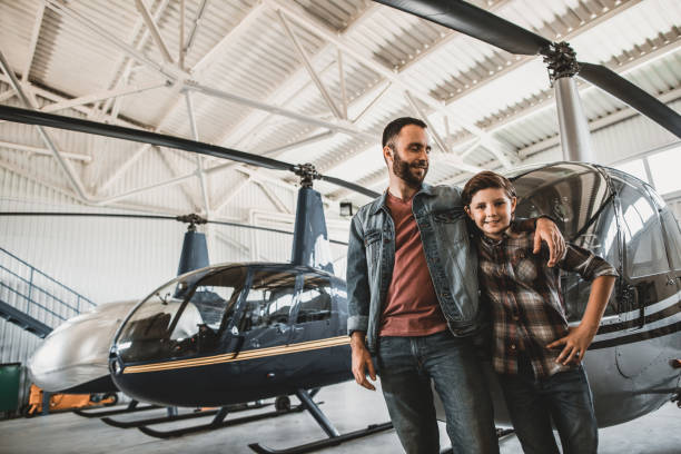 istock Cheerful male hugging child near rotor planes 1143244530