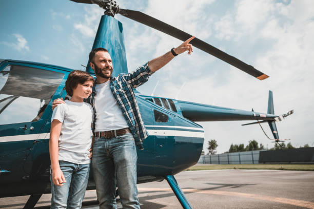 istock Cheerful male hugging boy on landing field 1143244585