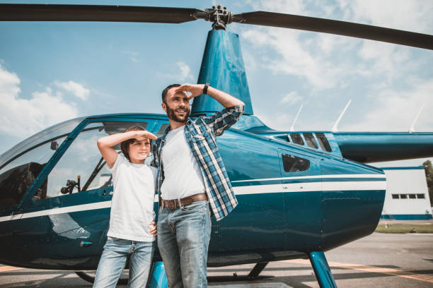 istock Pleased father and son standing near helicopter 1143244593
