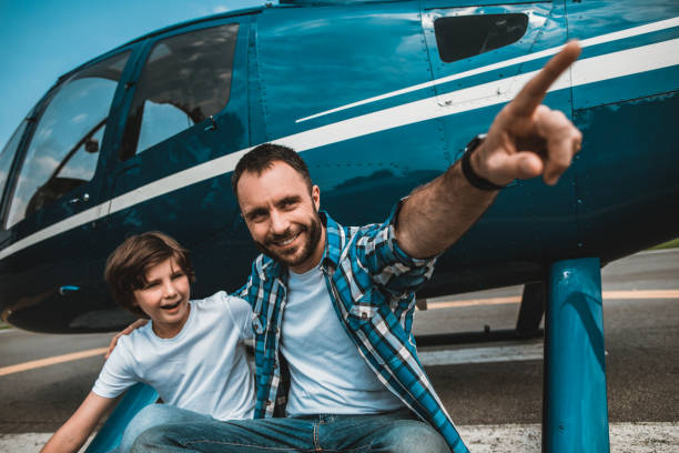 istock Cheerful dad talking with kid near helicopter 1143244636