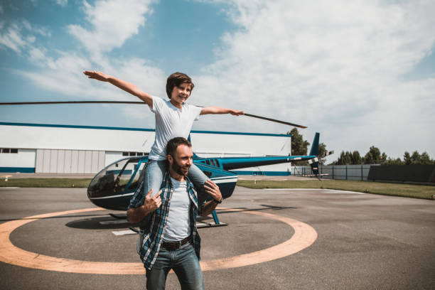 istock Beaming father having fun with cheerful kid 1143244645