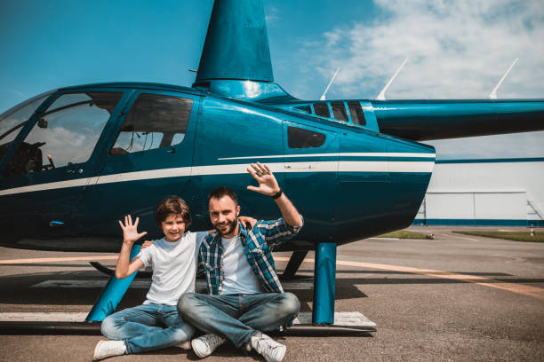 istock Beaming child and father relaxing near helicopter 1143244654