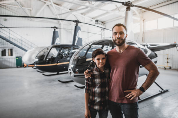 istock Optimistic male hugging satisfied kid opposite rotorcrafts 1143244687