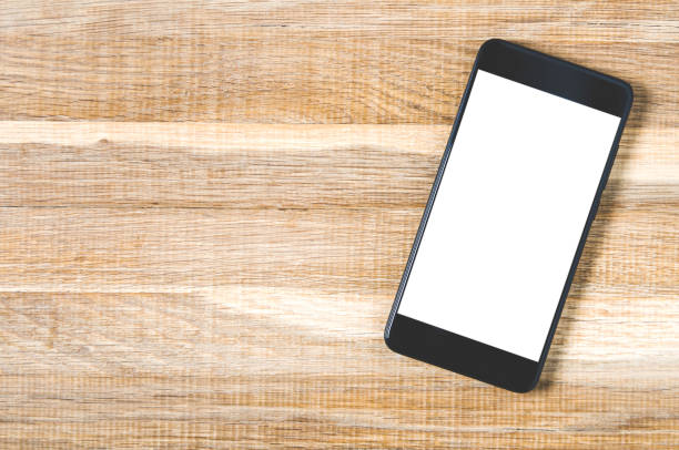 istock Black smartphone on wooden background. Template for text or design 1143244767