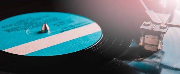 istock Vinyl record with blue label and old player 1143244784