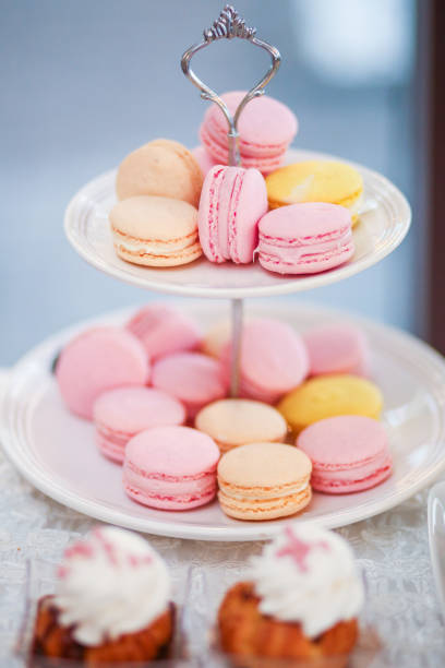 istock delicious pink and yellow macaroons on stander 1143247160