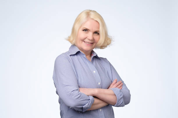istock Blonde older woman smiling and looking at camera 1143249563