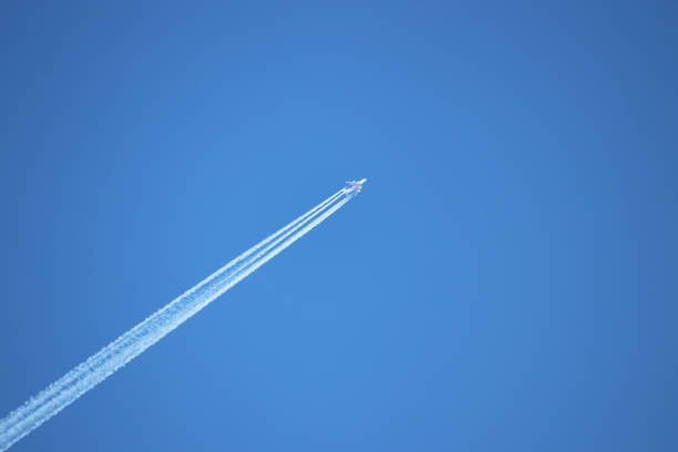 istock Trail of jet plane on clear blue sky 1143249779