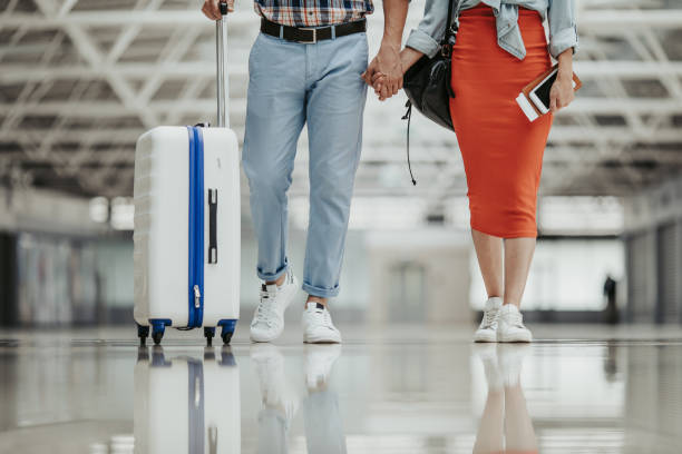 istock Man and lady walking with luggage 1143249837