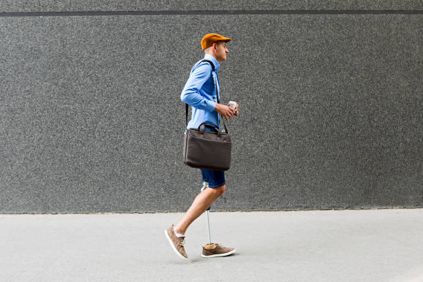 istock Young man with prosthetic leg walking 1143250136