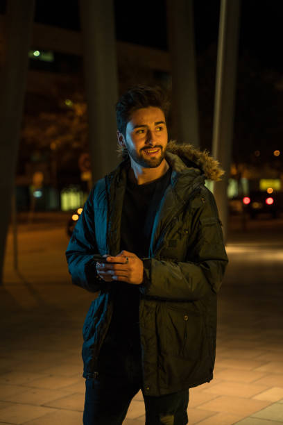 istock Young man text messaging in the city at night 1143250604