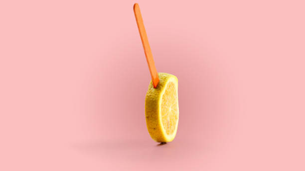 istock sliced orange fruit on a stick. pink background 1143251411