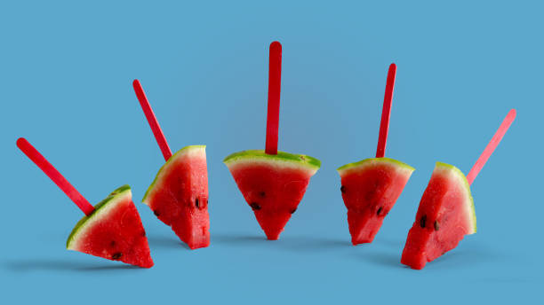 istock Watermelon popsicle yummy fresh summer fruit sweet dessert on blue background 1143251436