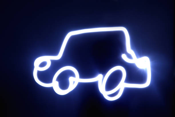 Car drawn with blue neon lights. Shot taken in the studio with a black background. Light painting drawn with blue neon LED lights.