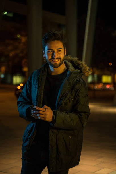 istock Young man text messaging in the city at night 1143253235