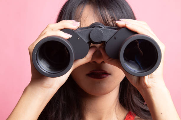istock Young Asian woman with binoculars. 1143253572