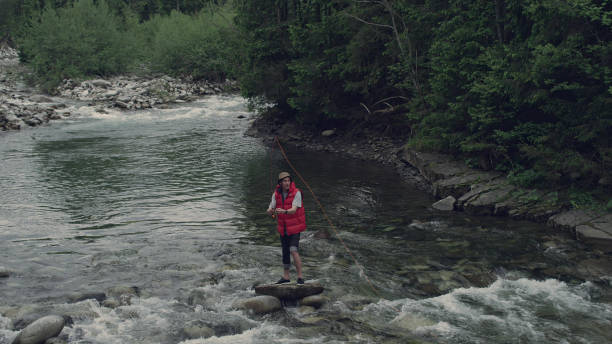 istock Man fishing in a mountain stream 1143253576