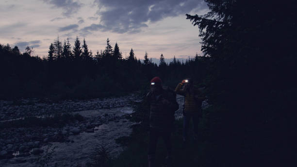 istock Young couple on a mountain trail. Night trip 1143253590