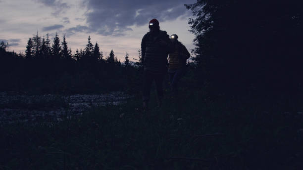 istock Young couple on a mountain trail. Night trip 1143253602