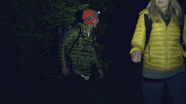 istock Young couple crossing mountain stream together. Night trip 1143253607
