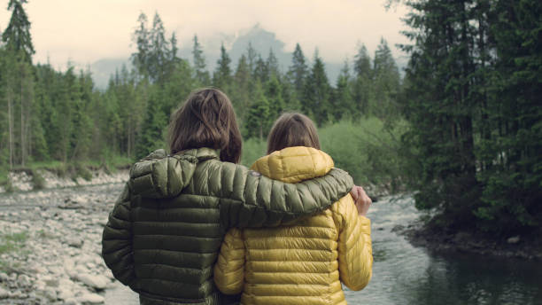 istock Young couple's mountain adventure. Looking at view 1143254013