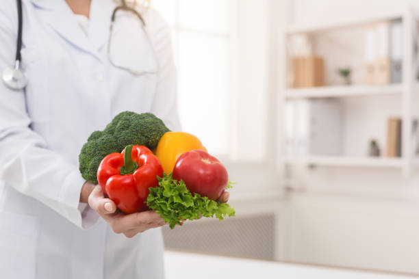istock Nutritionist holding fresh vegetables in her office 1143255353