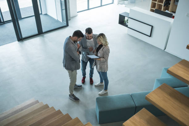 istock Three busuiness people having a casual talk in hall 1143256464